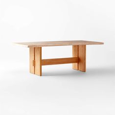 a wooden table sitting on top of a white floor