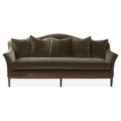 an image of a couch with pillows on it's back and arms in dark brown velvet