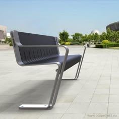 two metal benches sitting on top of a cement floor next to trees and buildings in the background