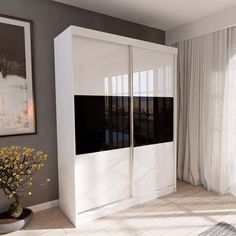 a white cabinet with sliding doors in a living room next to a painting on the wall