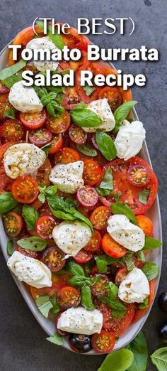 the best tomato burrata salad recipe on a platter with basil leaves and tomatoes