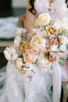 a bride holding a bouquet of flowers in her hand