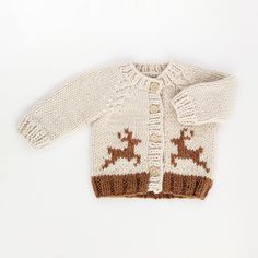 a knitted sweater with deers on it