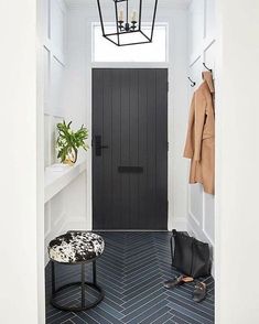 a black and white entryway with a coat rack