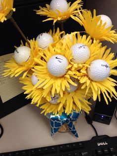 a vase filled with yellow flowers and golf balls