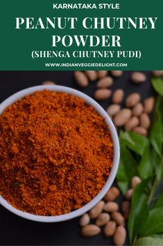 an image of peanut chutney powder in a white bowl with green leaves around it