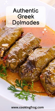 stuffed grape leaves on a white plate with tomato sauce and parsley sprig