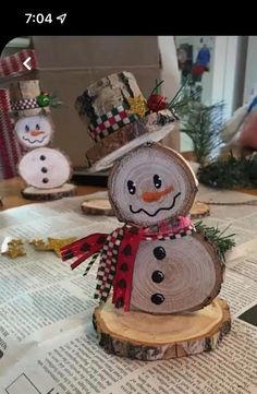 a snowman made out of wood sitting on top of a table