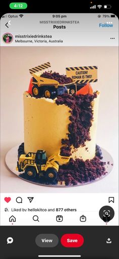 a cake that is on top of a plate with construction trucks in the middle of it