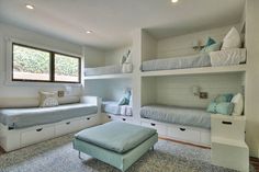 a bedroom with bunk beds and white furniture in the corner, along with a footstool