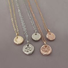 "A tiny pendant with a texture like stone. The pendant measures about a quarter of an inch or slightly larger. The pendant may be purchased separately. Chain choices include lengths of 16\" or 18\" and two chain styles, a delicate 7 mm twist cable chain or a sturdy 1.2 mm rolo chain. Chains and charm are made of solid 14k rose gold. Versatile and perfect for every day if worn alone, this necklace also combines well with other chains and charms. May be ordered with symbols and letters, and the pe Rose Gold Oval Pendant Necklace With Charms, Minimalist Necklaces With Round Pendant Charms, Rose Gold Necklaces With Charms And Round Pendant, Sterling Silver Rose Gold Coin Pendant Necklace, Rose Gold Sterling Silver Necklace With Coin Pendant, Rose Gold Necklace With Round Pendant Charms, Dainty Hammered Round Pendant Jewelry, Dainty Pendant Charm Necklaces For Meditation, Rose Gold Nickel-free Medallion Necklace