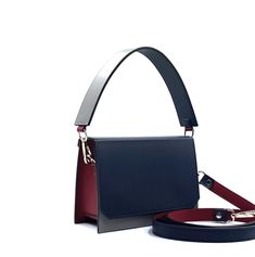 This blue and grey handbag, like all the others, uses our original ideas and handicrafts  Our quality is always higher than the price, see for yourself. This stylish women's handbag has a rectangular shape with straight lines and is of medium size. Made from high-quality smooth Italian leather. A wonderful combination of colors - dark blue, grey and burgundy. Luxury quality. One internal compartment, in the middle there is an intestine for various products. Lining with leatherette. The external valve is securely closed by two magnets. Bright fittings in nickel color. The set includes 2 leather straps, one 50-55 cm (not adjustable) for carrying in the hand or on the back of the elbow, the other 120 cm (adjustable) for carrying on the shoulder or over the shoulder. This leather bag is availa Blue Leather Bag, Gray Handbags, Blue Handbags, Leather Bag Women, Grey Leather, Blue Leather, Bago, Italian Leather, Leather Purses