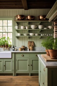 a kitchen filled with lots of green cupboards