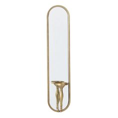 a gold candle holder with a mirror on the wall in front of it that is reflecting light