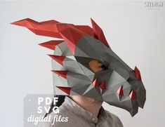 a man wearing a paper mask with red and grey spikes on it's head