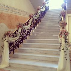 the stairs are decorated with flowers and ribbons