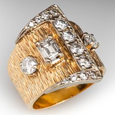 This great two-tone circa 1950s buckle ring is accented with one (1) prong set emerald cut diamond, one (1) prong set old European cut diamond, one (1) prong set round brilliant cut diamond, and twelve (12) bead set round brilliant cut diamonds. The yellow gold tapered shank has a bark finish. The ring measures 21.1mm at the top, rises 4.0mm above the finger, and tapers to 7.2mm wide by 1.1mm thick at the base of the shank.  It is currently a size 6. Luxury 22k Gold Diamond Cut Jewelry, Vintage Baguette Cut Diamond Accented Jewelry, Vintage Single Cut Baguette Diamond Jewelry, Vintage Baguette Cut Single Diamond Jewelry, Vintage Baguette Cut Diamond Jewelry, Vintage Diamond Rings With Rectangular Shape, Vintage Rectangular Rings With Brilliant Cut, Vintage Rectangular Brilliant Cut Rings, Retro Gold Diamond Ring For Formal Occasions