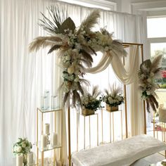 a room decorated with white flowers and greenery