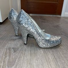 Qupid Silver Glitter Heels. Worn Once. Size 7. Almost Brand New. No Scuffs On Outside Shimmer Round Toe Heels For Prom, Shimmer Heels With Round Toe For Prom, Glitter Heels With Round Toe In Synthetic, Shimmer Round Toe Heels For Party Season, Holiday Sequined Heels With Round Toe, Glamorous Glitter Print Heels With Round Toe, Holiday Sequined Round Toe Heels, Glamorous Heels With Glitter Print, Sequined High Heels In Synthetic Material