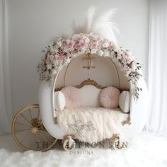 a white couch with flowers and feathers on it