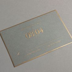 a silver and gold business card with the number forty80 on it's side