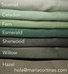 several different colors of linens stacked on top of each other with names in the middle