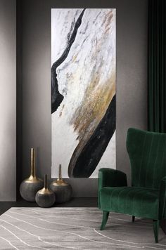 an abstract painting hangs on the wall next to a green chair and two vases