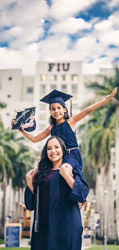 two young women in graduation gowns and caps are posing for the camera with their arms around each other