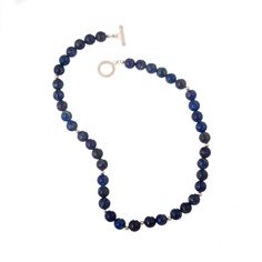 Accented by little sterling silver beads, the lapis lazuli gems look enchanting in this sophisticated and mysterious beaded necklace. Artisan Adriana de Gadea from Peru presents this handcrafted accessory in a blue hue with a shiny sterling silver toggle clasp for easy wear. Sapphire Beaded Necklaces With Natural Lapis Lazuli Stones, Sapphire-colored Lapis Lazuli Round Beaded Jewelry, Lapis Lazuli Jewelry With Faceted Beads, Sapphire Colored Lapis Lazuli Round Bead Jewelry, Lapis Lazuli Round Beads Jewelry For Healing, Sterling Silver Single Strand Beaded Necklace, Sodalite Gemstone Beads Necklaces, Sapphire Color Lapis Lazuli Necklace, Healing Lapis Lazuli Jewelry With Faceted Beads