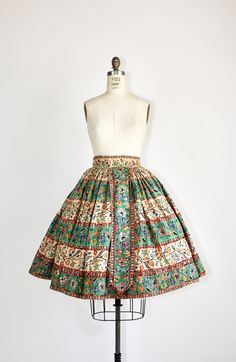 Vintage 1940s folk skirt. This heavy cotton skirt has a traditional bird and floral print. Translucent multicolor sequins decorate the patterning. Hook-and-eye closures at the waist, with snaps on the top side. Very full. Hand-stitched.  ❉ Era: 1940s ❉ Fits Like: extra small ❉ Tag size: -- ❉ Fabric: cotton ❉ Length: 26.5" ❉ Waist: 24" ❉ Hips: full ❉ Sweep: 136" ❉ Condition: There is a brown stain on the upper left side of the skirt; a few pulls; the top hook has some rust on it. While I don't notice any areas of missing sequins, there are A LOT of them, so it's possible there is one missing here or there. ❉ Smells/Odors: -- ------------ ❉ Sizing & Fit - All measurements are taken while the garment is lying flat, and the measurements are then doubled. A good suggestion for checking fit is t Vintage Multicolor Skirt, Vintage Cotton Floral Print Skirt, Vintage Cotton Skirt With Floral Print, Folk Skirt, Multicolor Sequins, Handmade Skirts, Folk Design, Skirt Vintage, Cotton Skirt