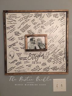 a couple's handwritten wedding guest signatures are framed on the wall