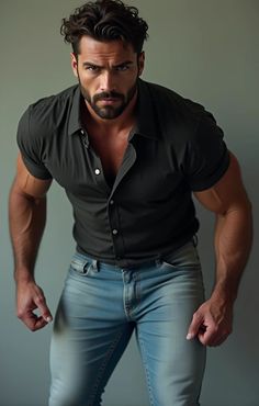 a man in jeans and a black shirt is posing for the camera with his hands on his hips