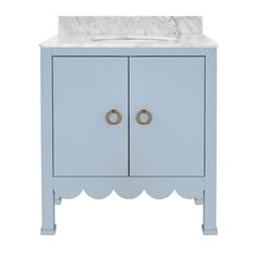 a bathroom vanity with a marble top and two gold rings on the front door handles