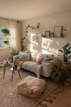 a living room filled with furniture and plants