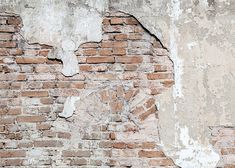 an old brick wall with peeling paint and chippings on it, including a clock