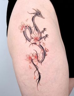 a woman's thigh with a dragon tattoo on it