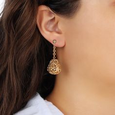 Adorn your ears with elegance and grace with these captivating clip-on earrings. The delicate bell-shaped filigree drops gracefully dangle from intricately linked chains, creating a subtle yet eye-catching movement. Designed for non-pierced ears, the secure clip ensures a comfortable and stylish fit, making these earrings a perfect accessory for any occasion. Available In Silver Tone And Gold Tone Measurements: 1.79" L x 0.65" W 1928 Jewelry Collection From the vaults of rich European capitals t Elegant Filigree Metal Clip-on Earrings, Elegant Metal Filigree Clip-on Earrings, Elegant Metal Chandelier Earrings With Filigree, Elegant Metal Filigree Chandelier Earrings, Elegant Metal Earrings With Dangling Charms, Elegant Gold Chandelier Earrings With Dangling Charms, 1928 Jewelry, Clip Earrings, Pierced Ears