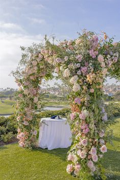 an outdoor ceremony setup with flowers and greenery