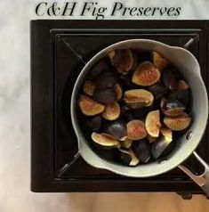 a pan filled with figs sitting on top of a counter