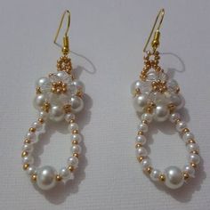 The pair of earring it's made by glass pearls beads and gold Japanese miyuki seed beads and gold plated earring hooks.  Elegant. Victorian. white bridal earring amazing matching with white and gold outfit. vibrant white to create the perfect eye catching accessory. Bridal Earring, Gold Outfit, Ear Weights, Perfect Eyes, White Bridal, Earring Hooks, Gold Plated Earrings, Bridal Earrings, Pearl Beads