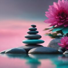 some rocks and pink flowers with water in the foreground on a reflective table top