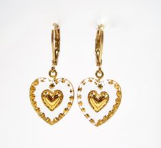 Positive vibes sweet earrings heart made of gold handmade glass stones 18ct gold plated glass earrings pendants made in germany 1970 The earrings shown are handmade in Germany. The metal is brass 18kt gold-plated The heart pendants are handmade Bohemian glass from the 1970s. Total length: approx. 32 mm Size pendant: 15x14 mm Brand: SoHo® We only use materials from Germany for these earrings. All work steps are lovingly handcrafted under fair conditions in Germany. The sockets and earring are sol Valentine's Day Gold Pendant Earrings, Vintage Gold Heart Earrings Nickel Free, Vintage Gold Nickel-free Heart Earrings, Handmade Yellow Gold Heart Earrings For Valentine's Day, Vintage Gold Heart Dangle Earrings, Vintage Gold Dangle Heart Earrings, Gold Dangle Heart Earrings As Gift, Gold Dangle Heart Earrings For Gift, Gold Heart Pendant Earrings, Nickel-free