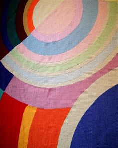 a multicolored area rug with circles on it