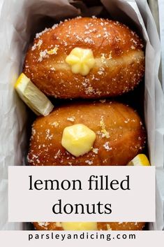 two lemon filled donuts in a paper bag with butter on top and the words, lemon filled donuts