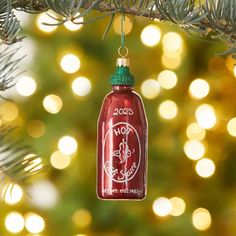 a red ornament hanging from a christmas tree