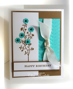 a happy birthday card with blue flowers and a white ribbon