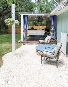 a patio with chairs and a table in it