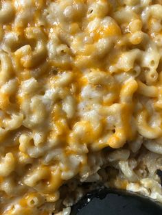 macaroni and cheese is being cooked in a skillet