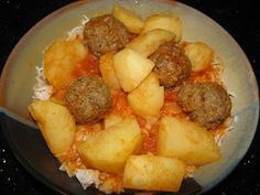 a plate with meatballs and potatoes on it