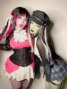 two women dressed in costumes posing for the camera